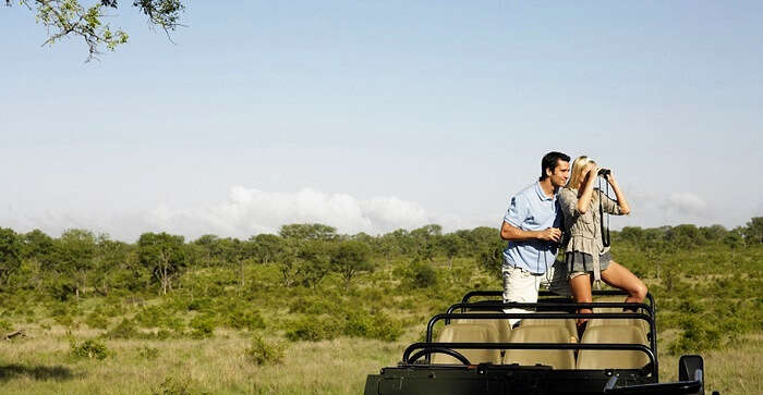 couple enjoying jeep safari on honeymoon in Namibia