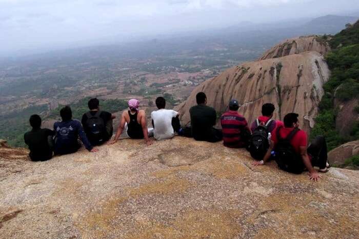 Group of friends sitting atop the hill in Savandurga near Bangalore