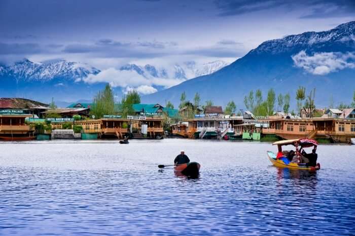 Shikara infront of a houseboat in Kashmir