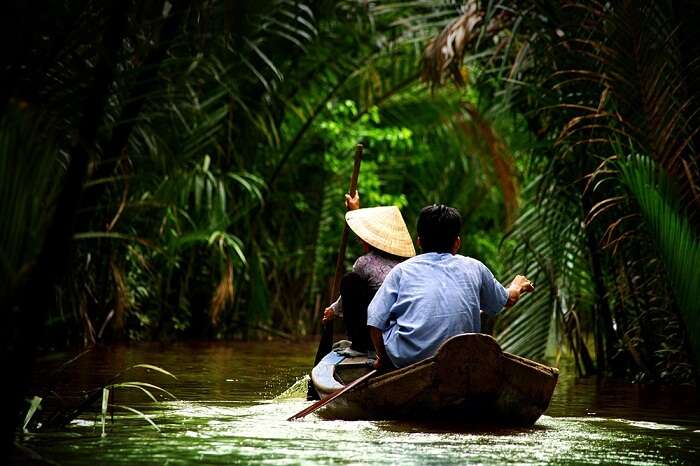 Vietnamese people paddling in the Mekong delta in Ho Chi Minh city