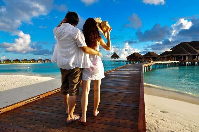 Couple on a pathway of luxury resort in Maldives
