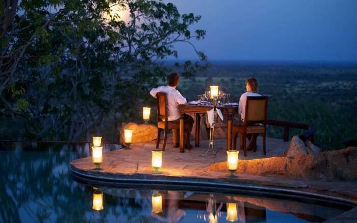 Couple watching the sunset during a safari honeymoon in South Africa ss29052017