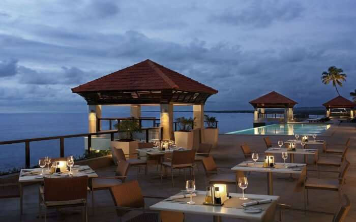 romantic dinner at a rooftop restaurant in The Leela Kovalam