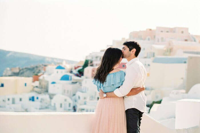 a young honeymoon couple in Santorini
