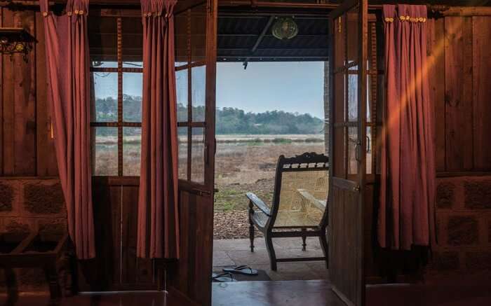 A room of Olaulim Backyards overlooking the vast stretch of land in Goa