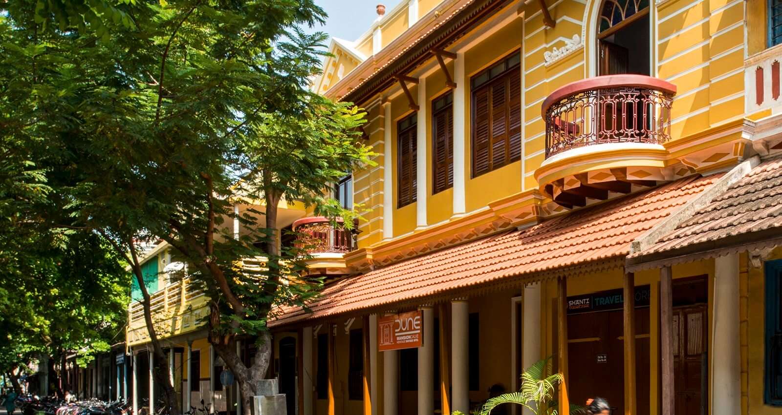 A south Indian style cottage surrounded by palms