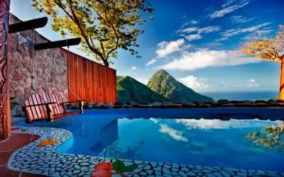 outdoor pool of a resort overlooking conical mountains