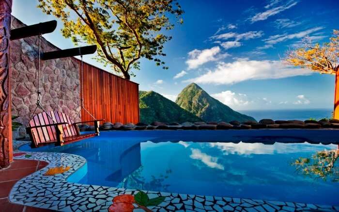 outdoor pool of a resort overlooking conical mountains