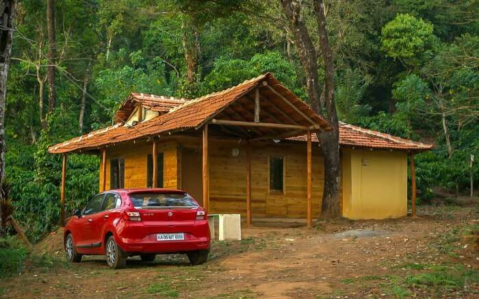 A car parked outside 27trees Homestay in Coorg 