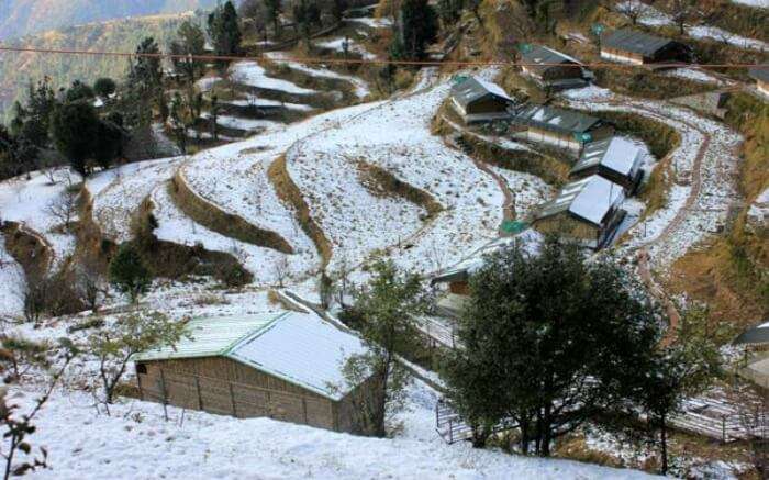 Camps of Little Jaguar on the contours of hill covered in snow 