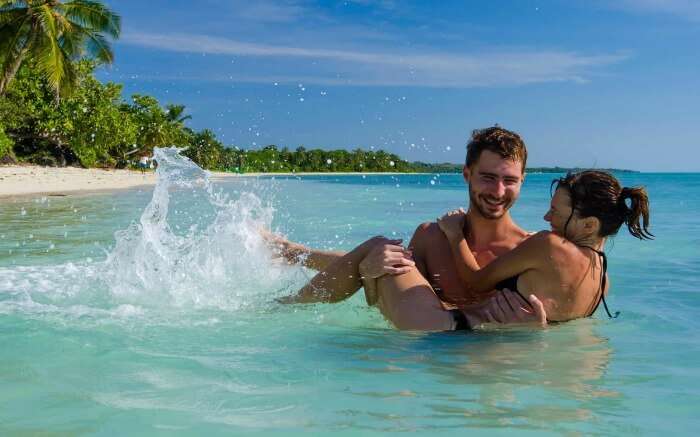 Couple spending playful time in the turquoise waters of Madagascar