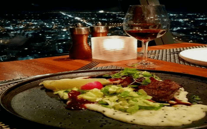 Dinner laid out on the dining table at 360-degree dining in Skytower which one of the most famous places for New Year party in Pune