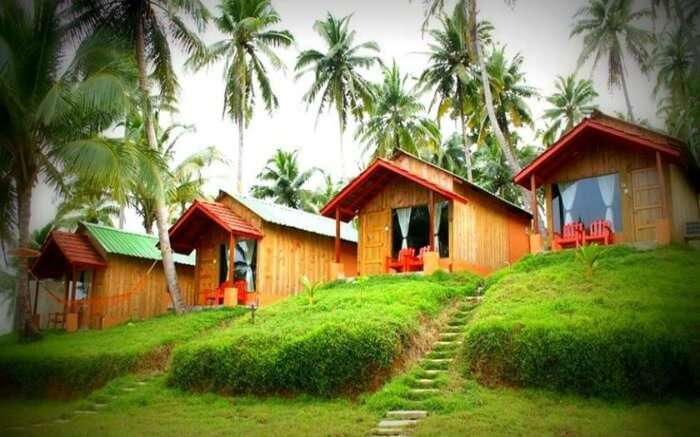 Picturesque cottages of The Oceanus Resort lined up by the seaside in Port Blair