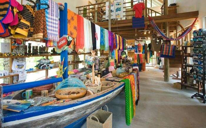 Colourful clothes on a wooden boat in a shop