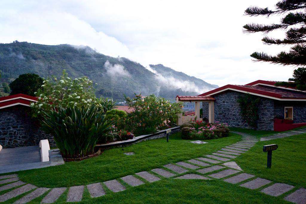 a green paved lawn of a resort in Kodaikanal hills