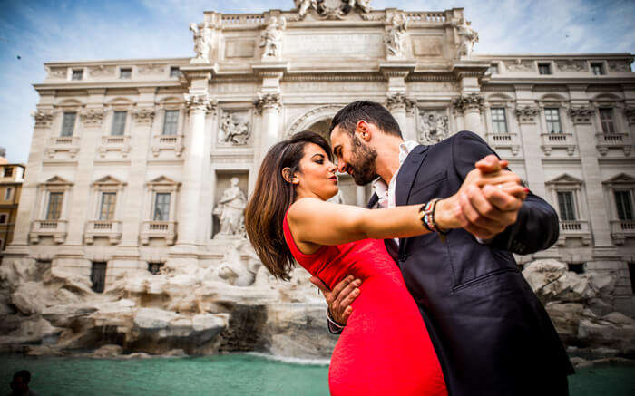 A couple in front of Trevi Fountain in Rome