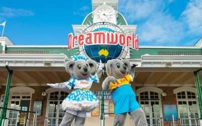 Two cartoon characters in front of Dreamworld theme park