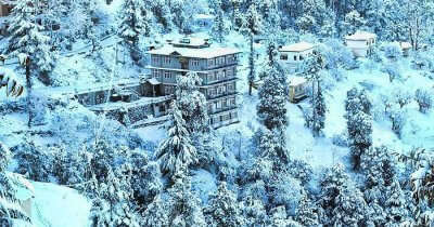 Snow-covered hills surrounding the Hotel Ekant in Chail