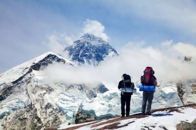 two climbers looking at the snow laden mountains