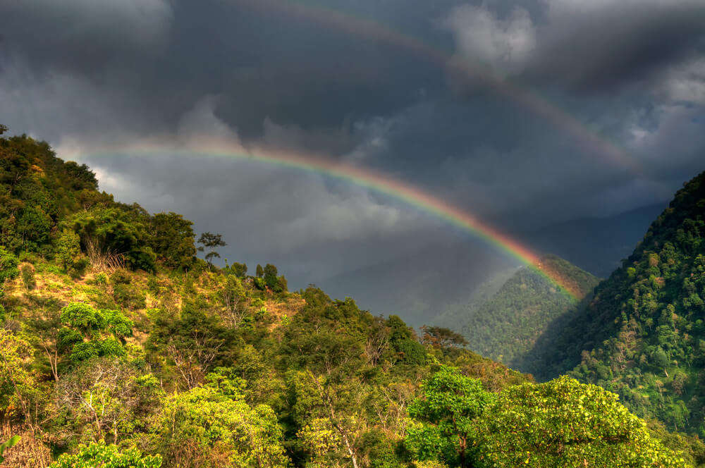 a beautiful rainbow over mountains