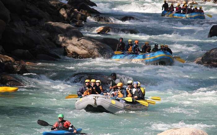 Adventurers rafting in a boat in a river in Nepal