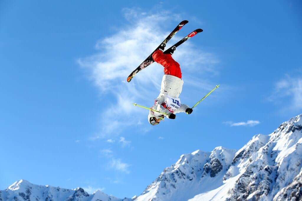 a guy flipping in the air while skiing