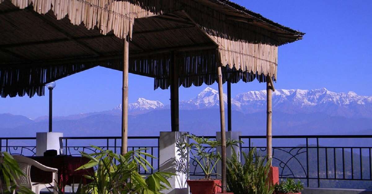 wooden hut with snow clad mountain views