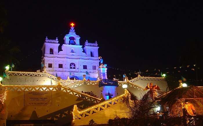 https://assets.traveltriangle.com/blog/wp-content/uploads/2017/10/A-well-lit-church-at-night-in-goa-ss05102017.jpg