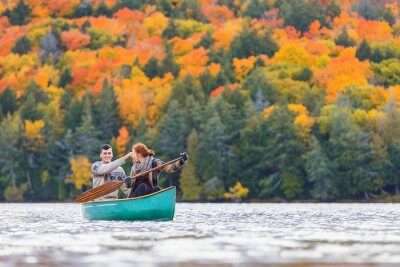 a couple rowing in a lake in canada