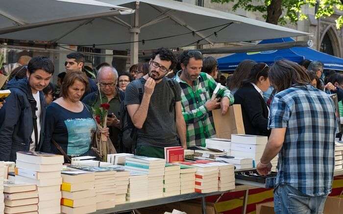 People at literary art festival buying books 