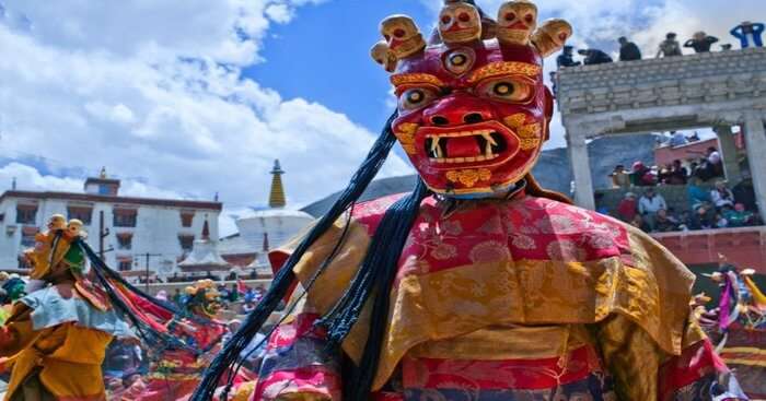 a man wearing red mast during losar festival