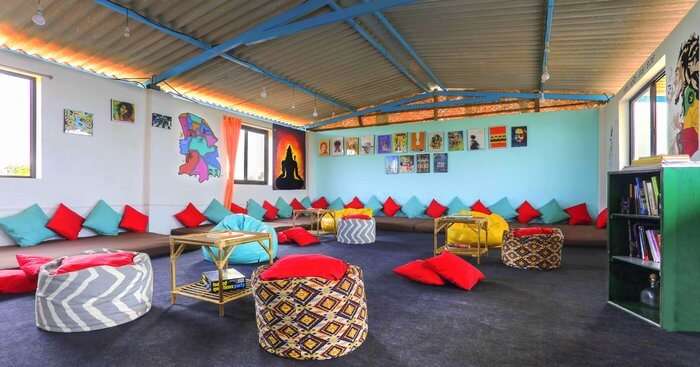 a sitting room of a hotel with colorful pillows