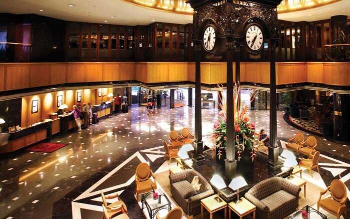 A gorgeous lounge area of a hotel with a huge clock 