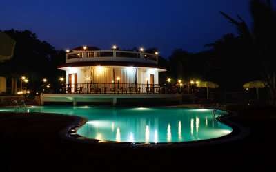 A well lit Golden Toff Resort with a glittering swimming pool at night