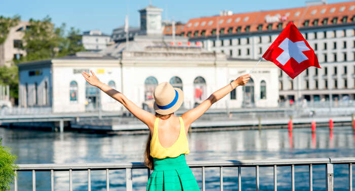 a girl holding Switzerland flag