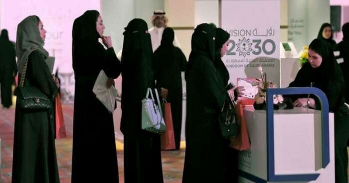Female travelers in Arabia at the ticket counter on airport