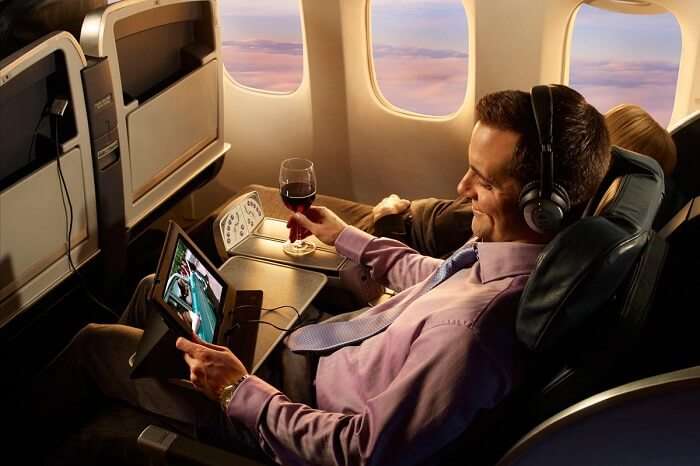 a passenger enjoying internet services to watch a video on personal device on flight