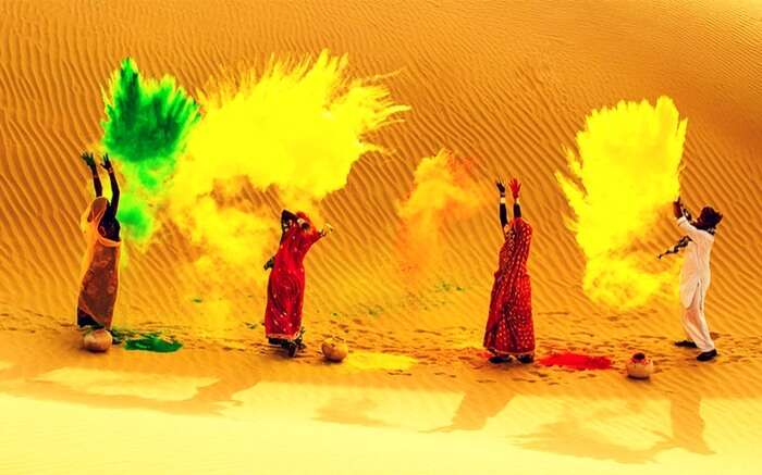 Rajasthani men and women celebrating Holi in desert