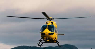 a yellow heli taxi in air
