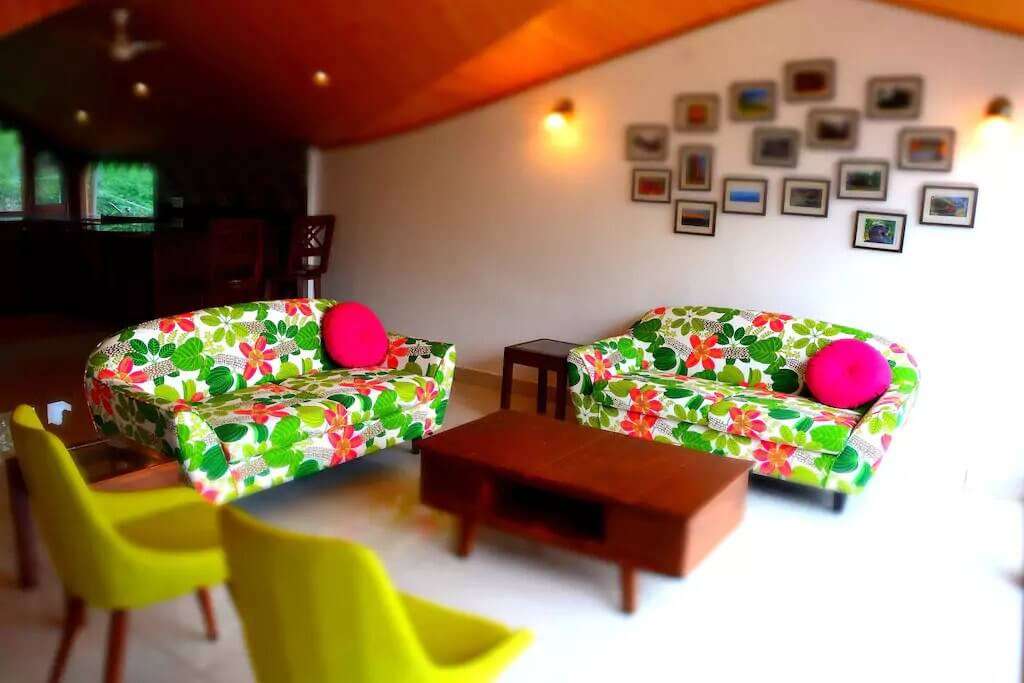 colourful sofas in the living room of a cottage