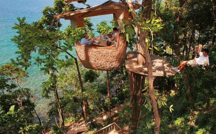 A view of people dining at Soneva Kiri Resort in Thailand