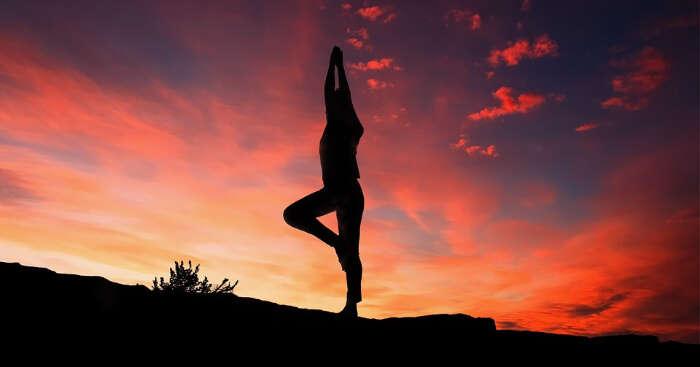 somebody doing yoga during twilight