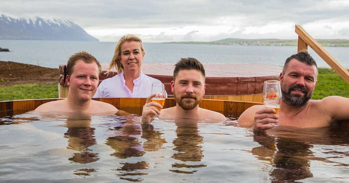 people in a wooden tub filled with beer