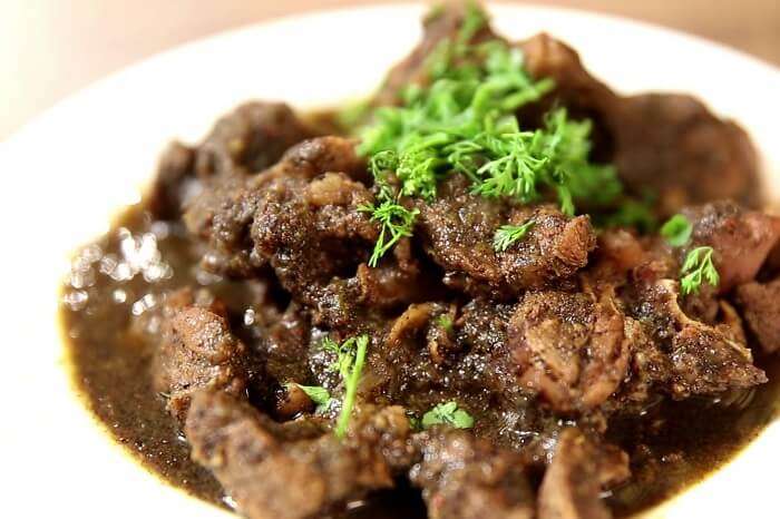 Relish ‘pandi curry’ and ‘akki rotti’ coorg