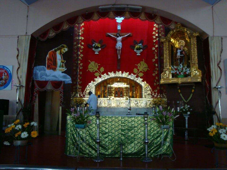 alter of a church decorated with colourful clothes