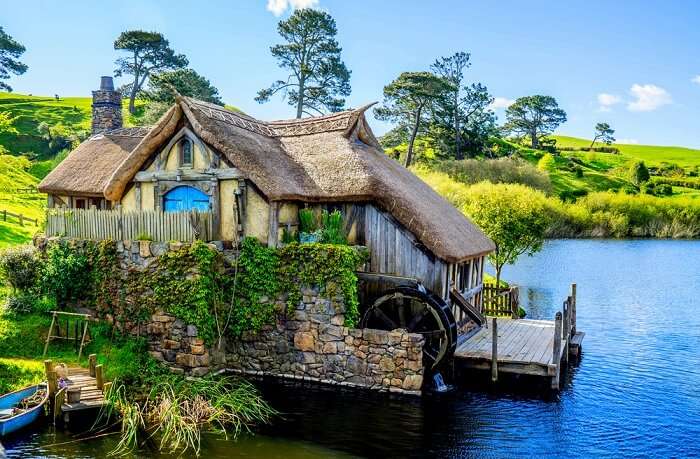 a beautiful Hobbit house by a lake