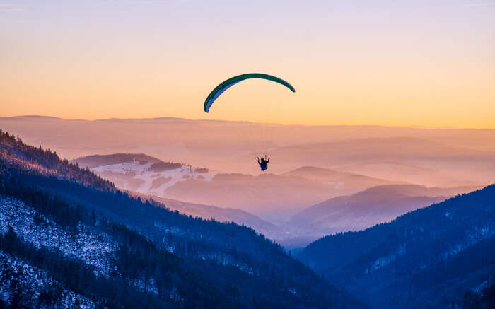 A paraglider in mountains