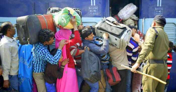 people carrying luggage in Indian train