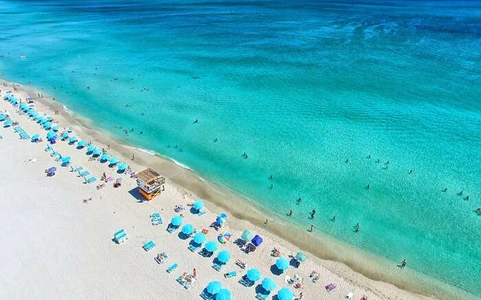 a gorgeous blue beach with blue sundecks