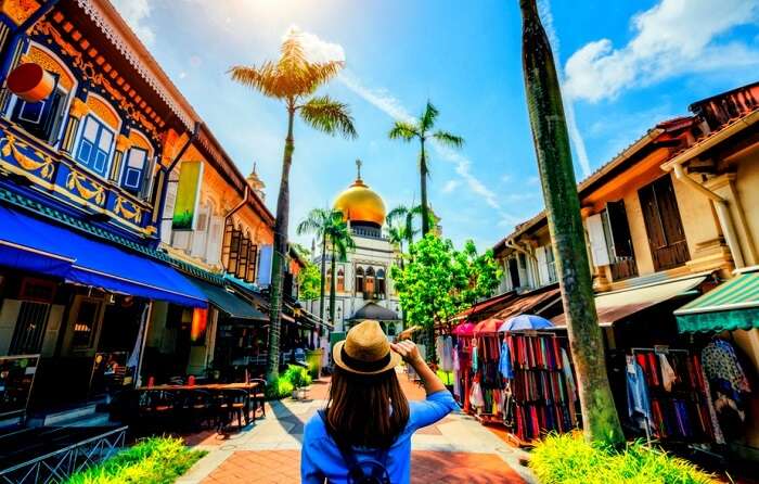 woman holding a hat near famous market